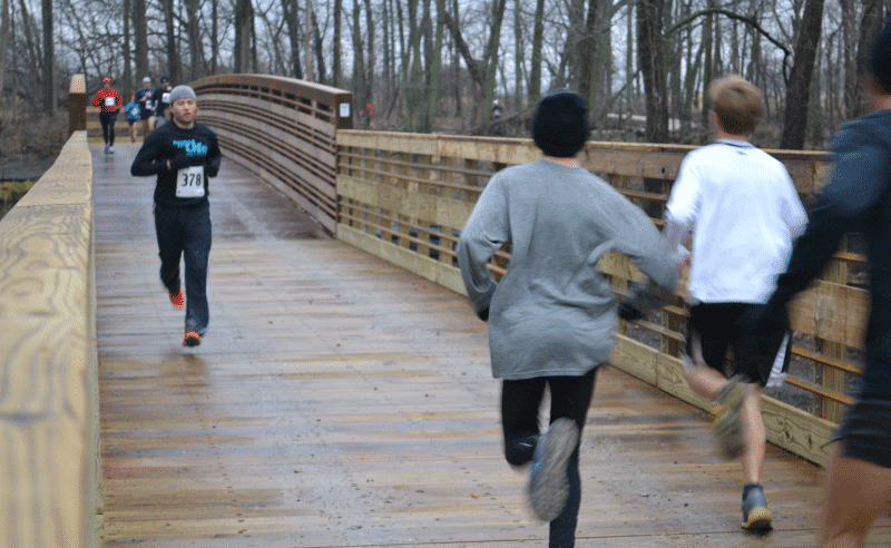 People Running on Bridge